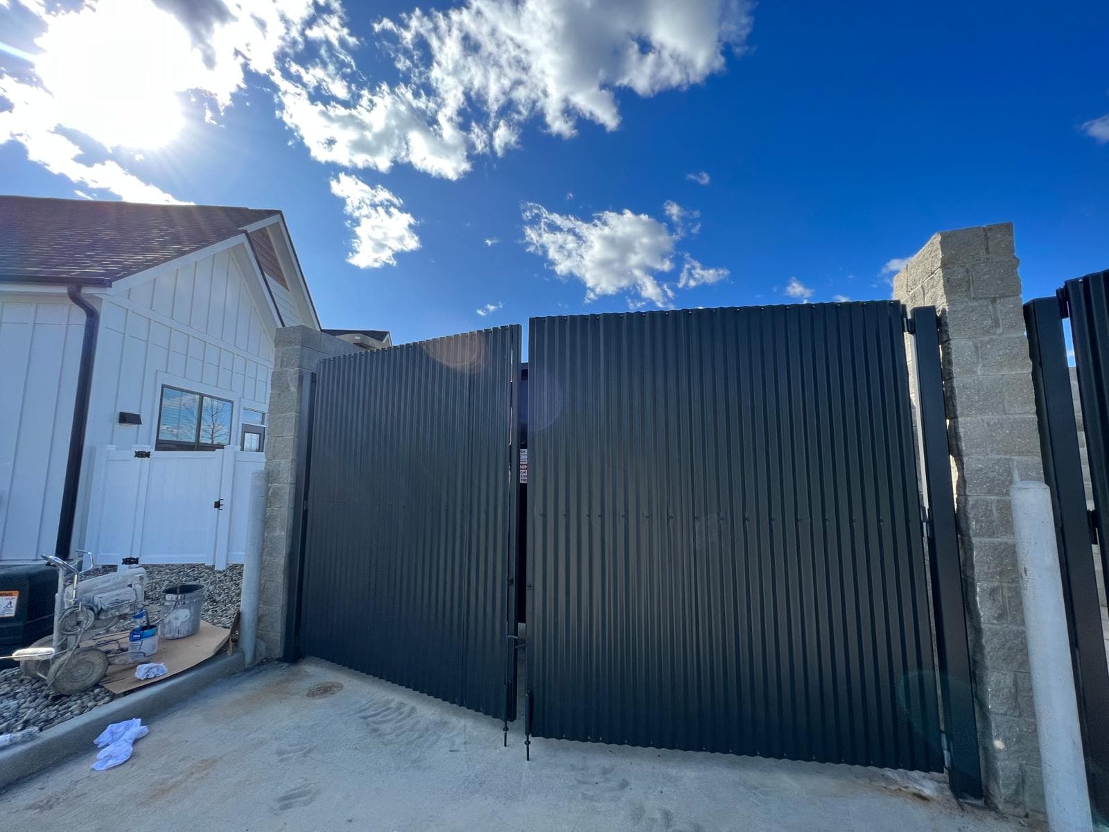 Dark painted fence with stone pillars